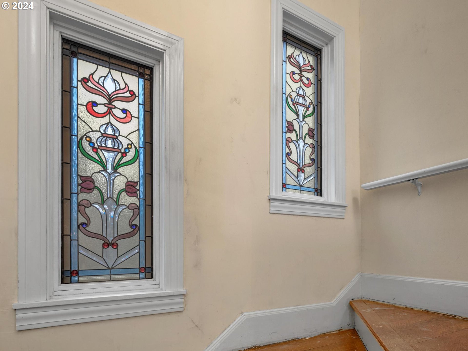 5523 Southwest Menefee Drive Portland, OR 97239 - Photo 13 of 22 a hallway with a painting on the wall and a window