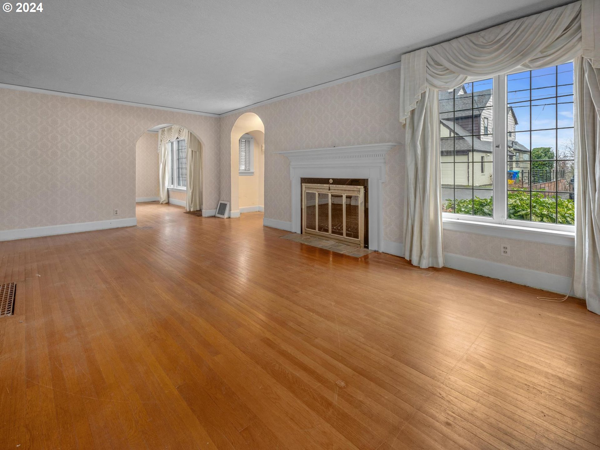 5523 Southwest Menefee Drive Portland, OR 97239 - Photo 3 of 22 a view of a livingroom with wooden floor and a fireplace