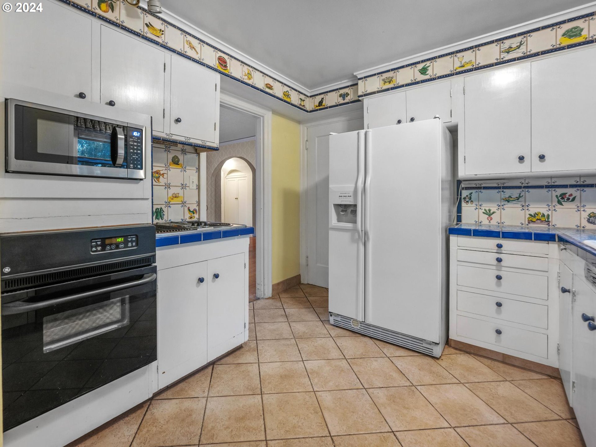 5523 Southwest Menefee Drive Portland, OR 97239 - Photo 6 of 22 a kitchen with granite countertop cabinets and steel stainless steel appliances
