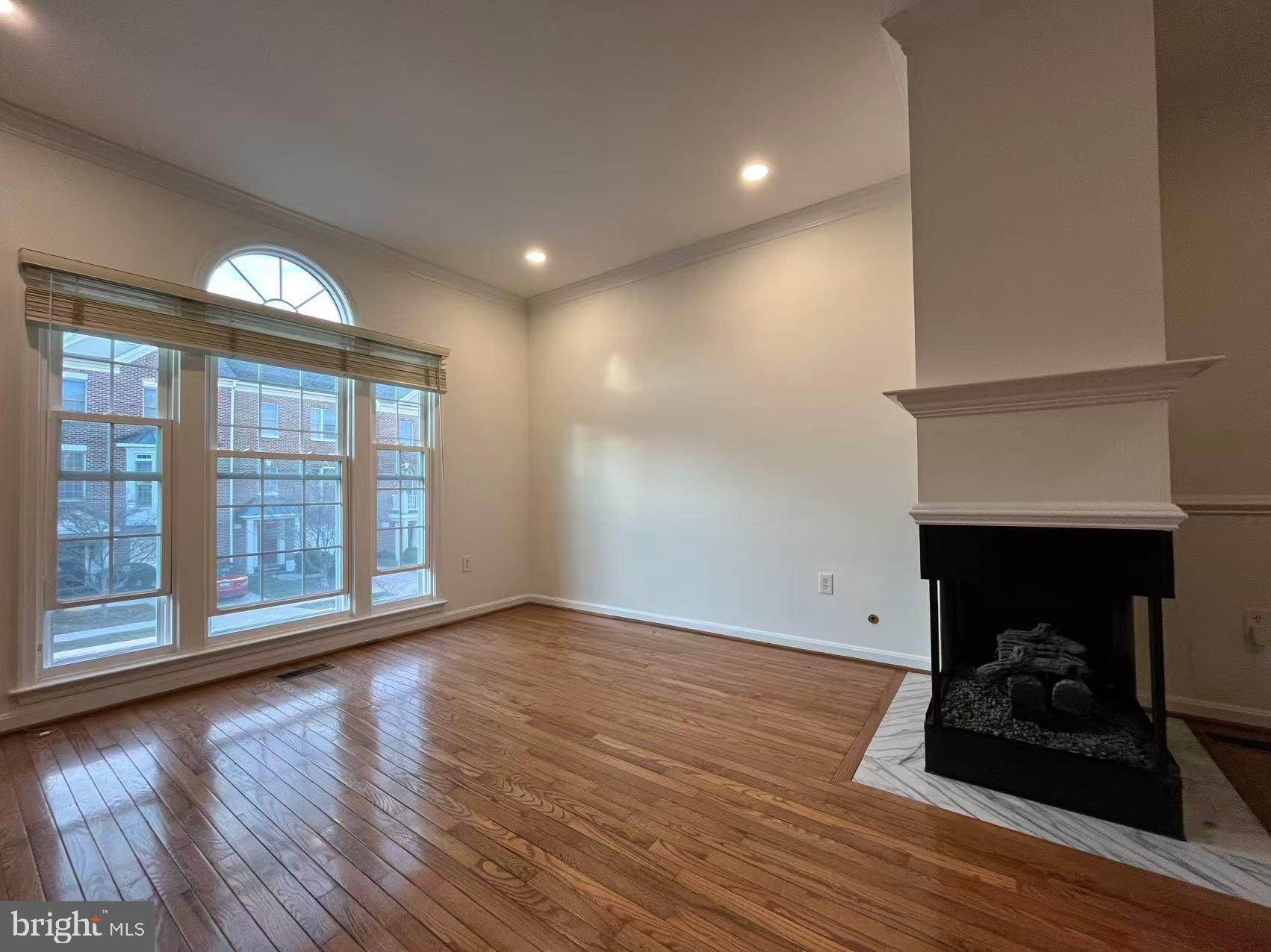 4102 Kentmere Square Fairfax, VA 22030 - Photo 11 of 55 a view of an empty room with wooden floor and a fireplace