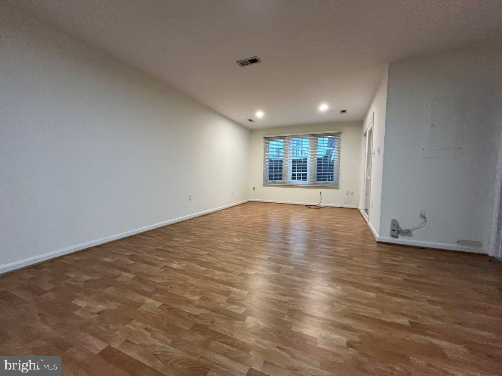 4102 Kentmere Square Fairfax, VA 22030 - Photo 15 of 55 an empty room with wooden floor and windows