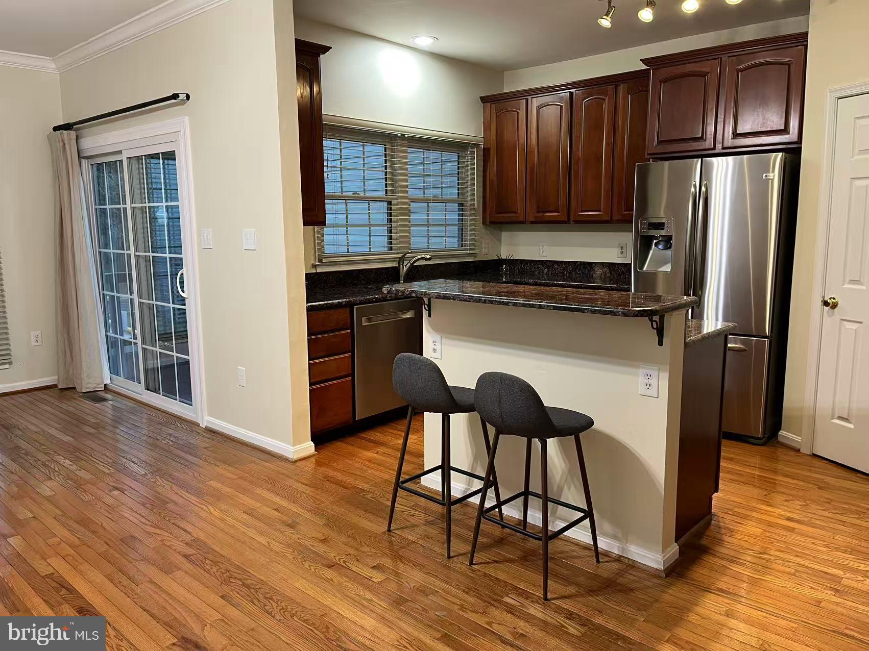 4102 Kentmere Square Fairfax, VA 22030 - Photo 20 of 55 a kitchen with a wooden floor and a refrigerator