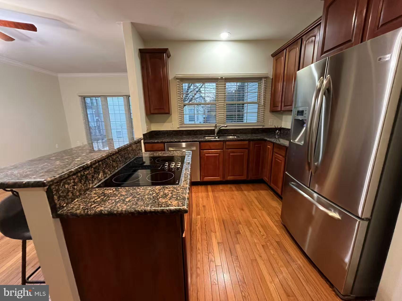 4102 Kentmere Square Fairfax, VA 22030 - Photo 23 of 55 a kitchen with granite countertop stainless steel appliances a refrigerator stove top oven and sink