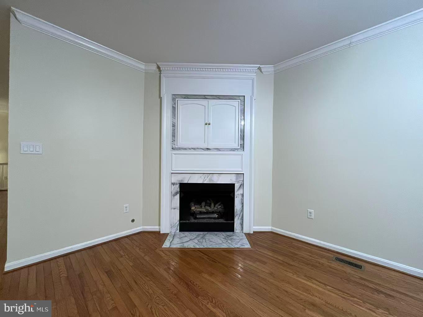 4102 Kentmere Square Fairfax, VA 22030 - Photo 29 of 55 a view of an empty room with wooden floor and fireplace