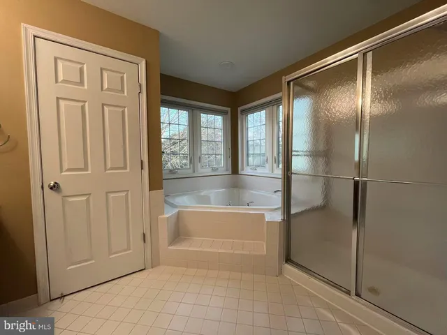 a bathroom with a bathtub and a shower