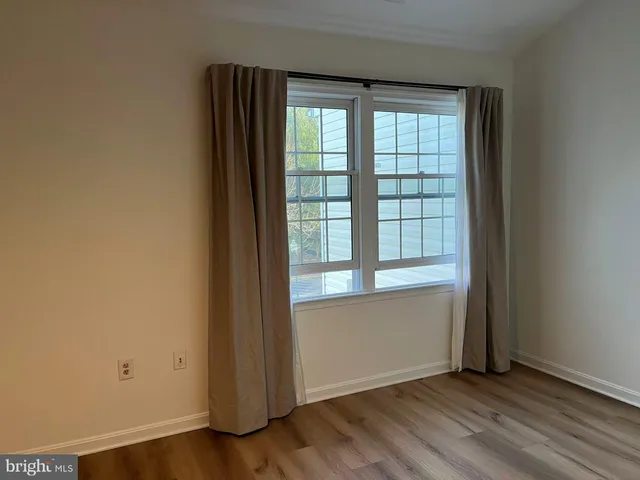 a bathroom with a granite countertop sink a toilet a mirror a bathtub and shower