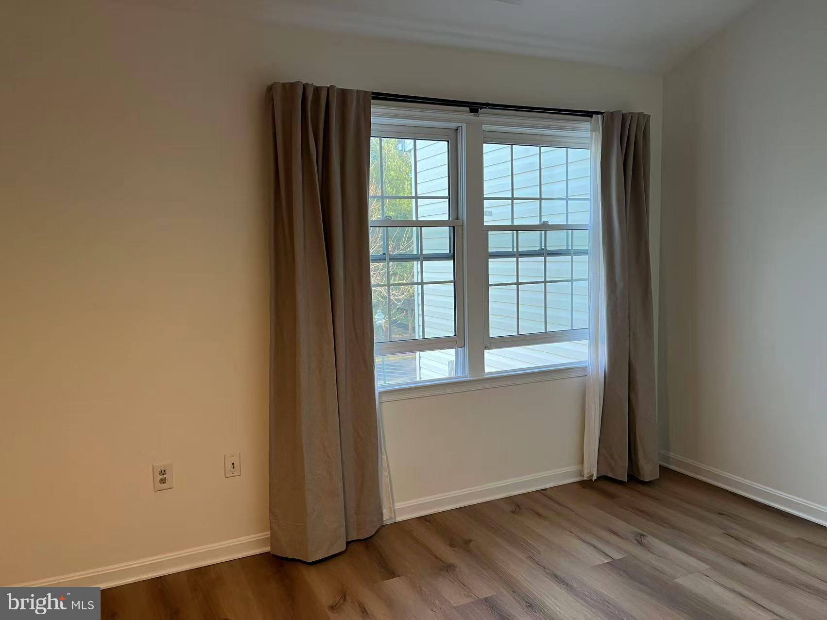 4102 Kentmere Square Fairfax, VA 22030 - Photo 35 of 55 an empty room with wooden floor and windows