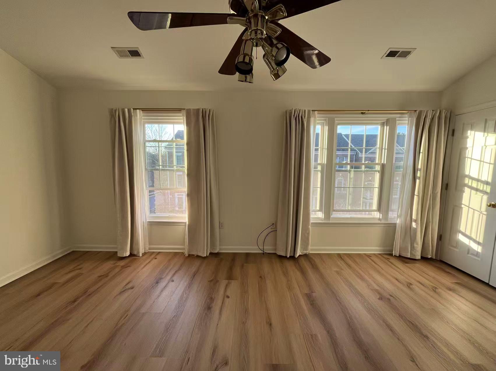 4102 Kentmere Square Fairfax, VA 22030 - Photo 40 of 55 a view of an empty room with wooden floor and a window