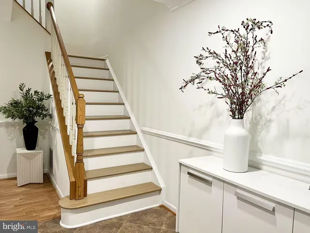 a view of entryway and hall with wooden floor