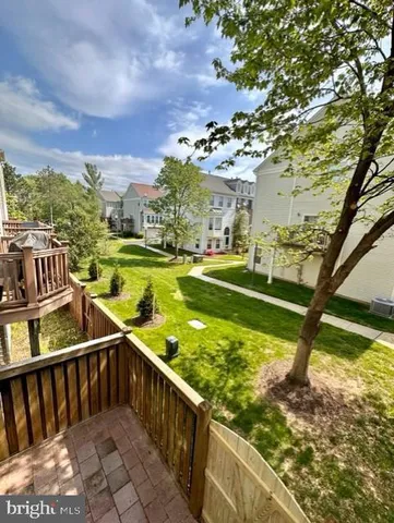 a view of balcony with wooden floor and outdoor seating