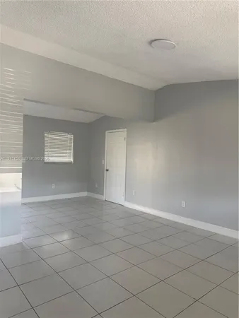 a view of an empty room and a window