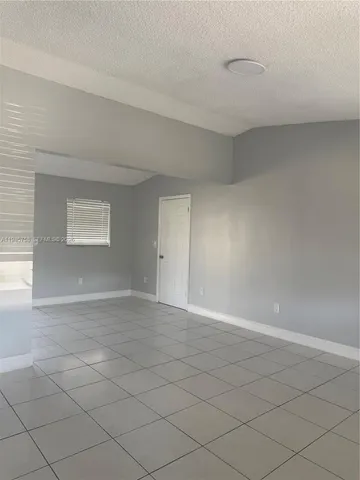 a view of an empty room and a window