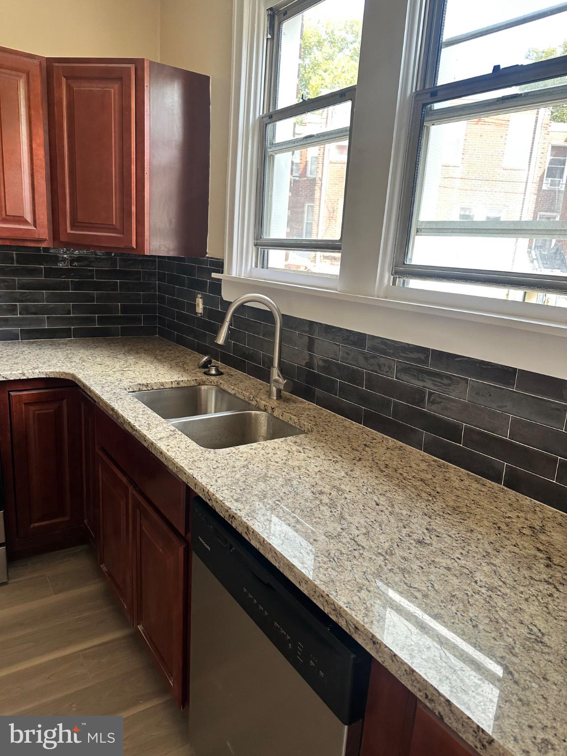 2146 East Washington Lane Philadelphia, PA 19138 - Photo 13 of 32 a kitchen with granite countertop sink and window