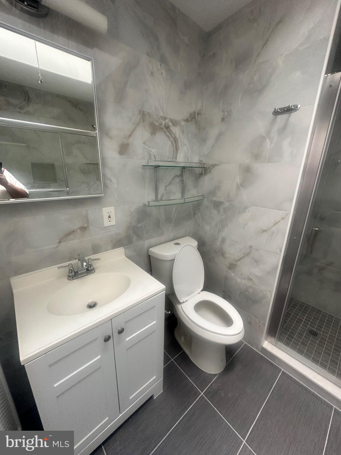 2146 East Washington Lane Philadelphia, PA 19138 - Photo 25 of 32 a white toilet sitting next to a bathroom sink