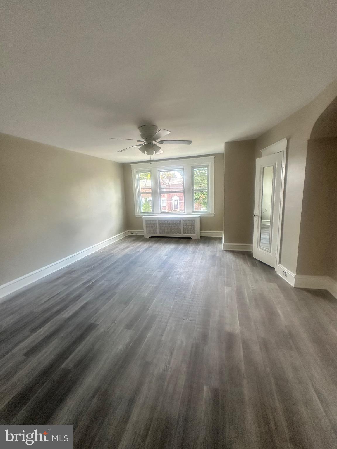 2146 East Washington Lane Philadelphia, PA 19138 - Photo 30 of 32 an empty room with wooden floor and windows