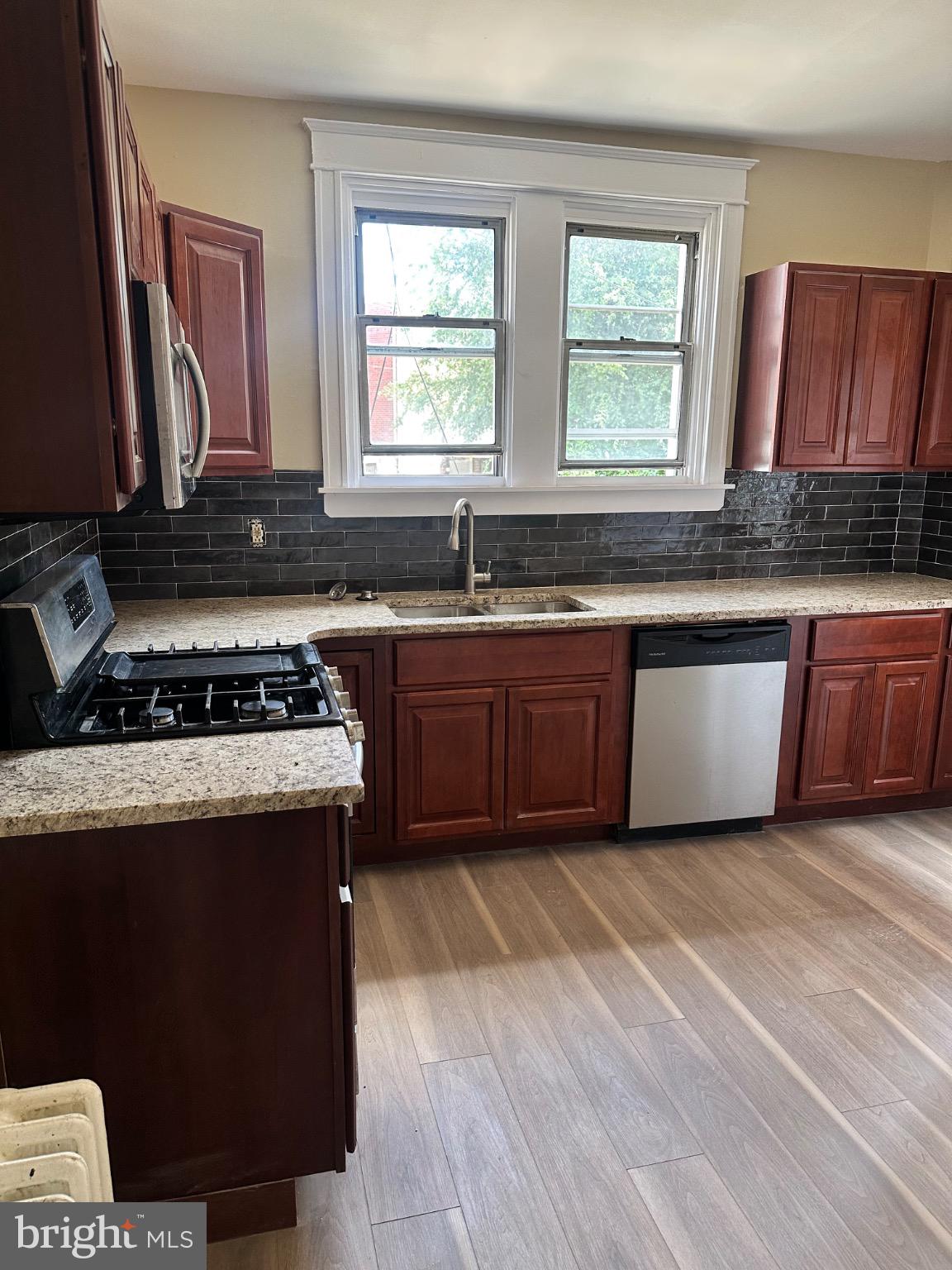 2146 East Washington Lane Philadelphia, PA 19138 - Photo 8 of 32 a kitchen with stainless steel appliances granite countertop a stove a sink and a microwave