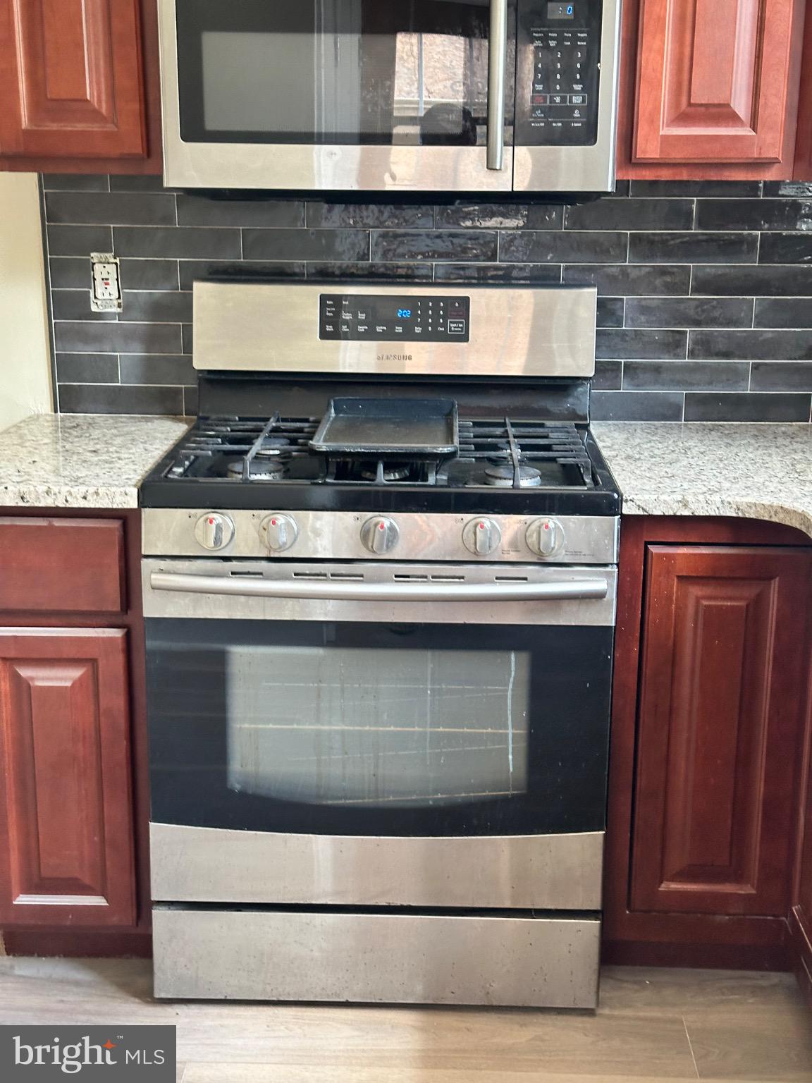 2146 East Washington Lane Philadelphia, PA 19138 - Photo 10 of 32 a stove top oven sitting inside of a kitchen