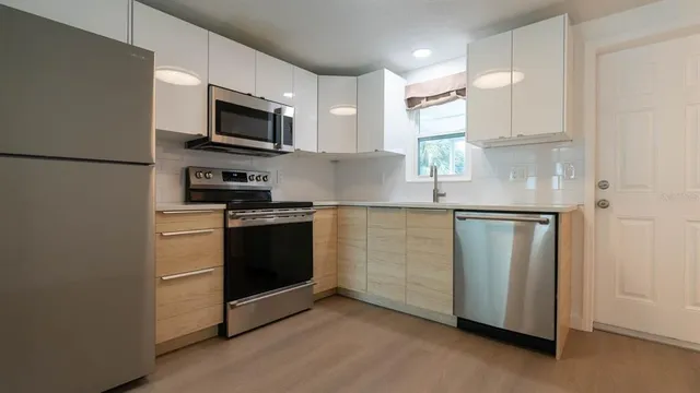 a kitchen with a refrigerator stove and microwave