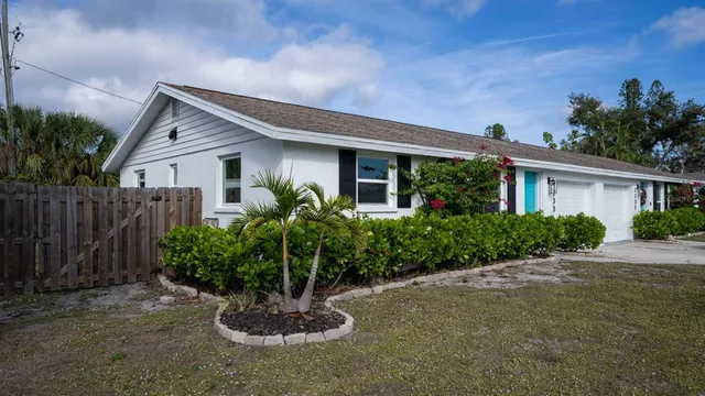 a front view of a house with a yard and a garage