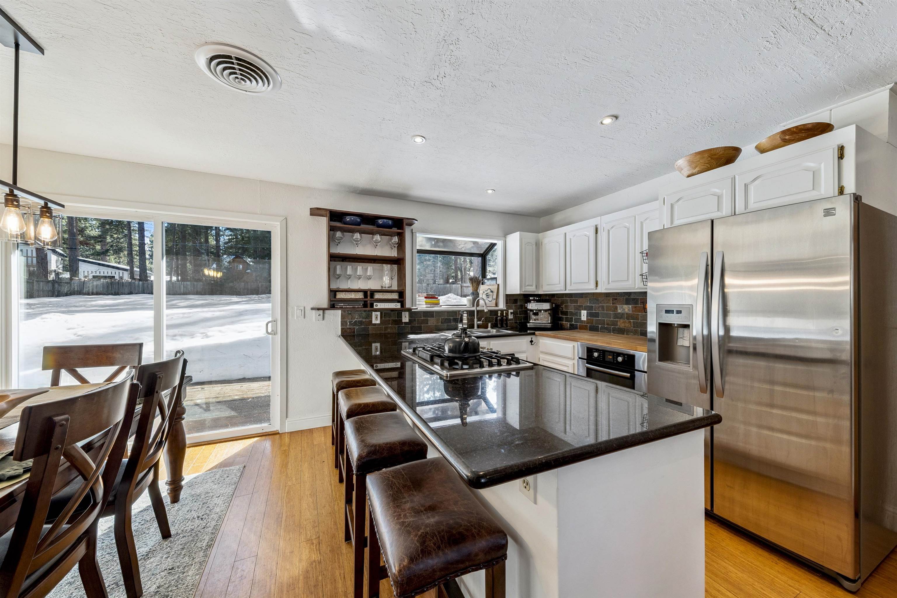 10895 Jeffery Pine Road Truckee, CA 96161 - Photo 12 of 25 a kitchen with stainless steel appliances granite countertop a sink refrigerator and cabinets