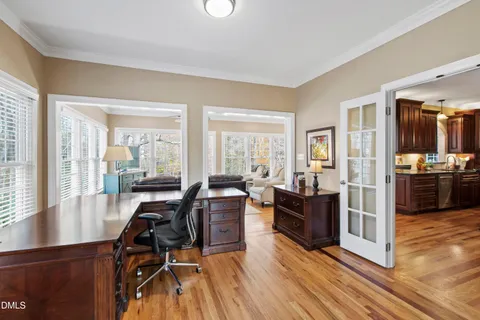 a view of a dining room with furniture large windows and wooden floor