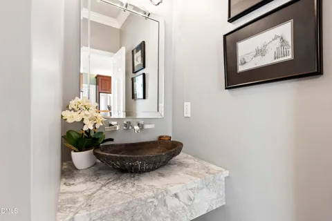 a kitchen with granite countertop a refrigerator a stove a dining table and chairs with wooden floor