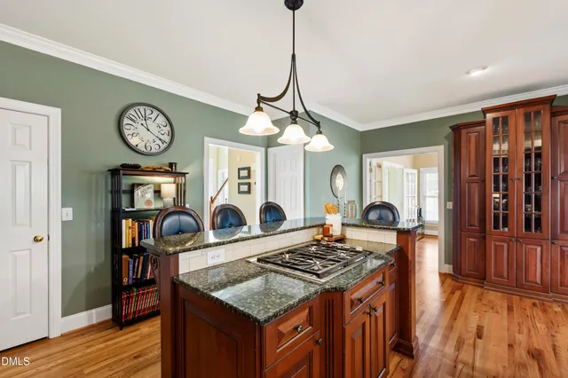 a dining room with furniture a chandelier and wooden floor