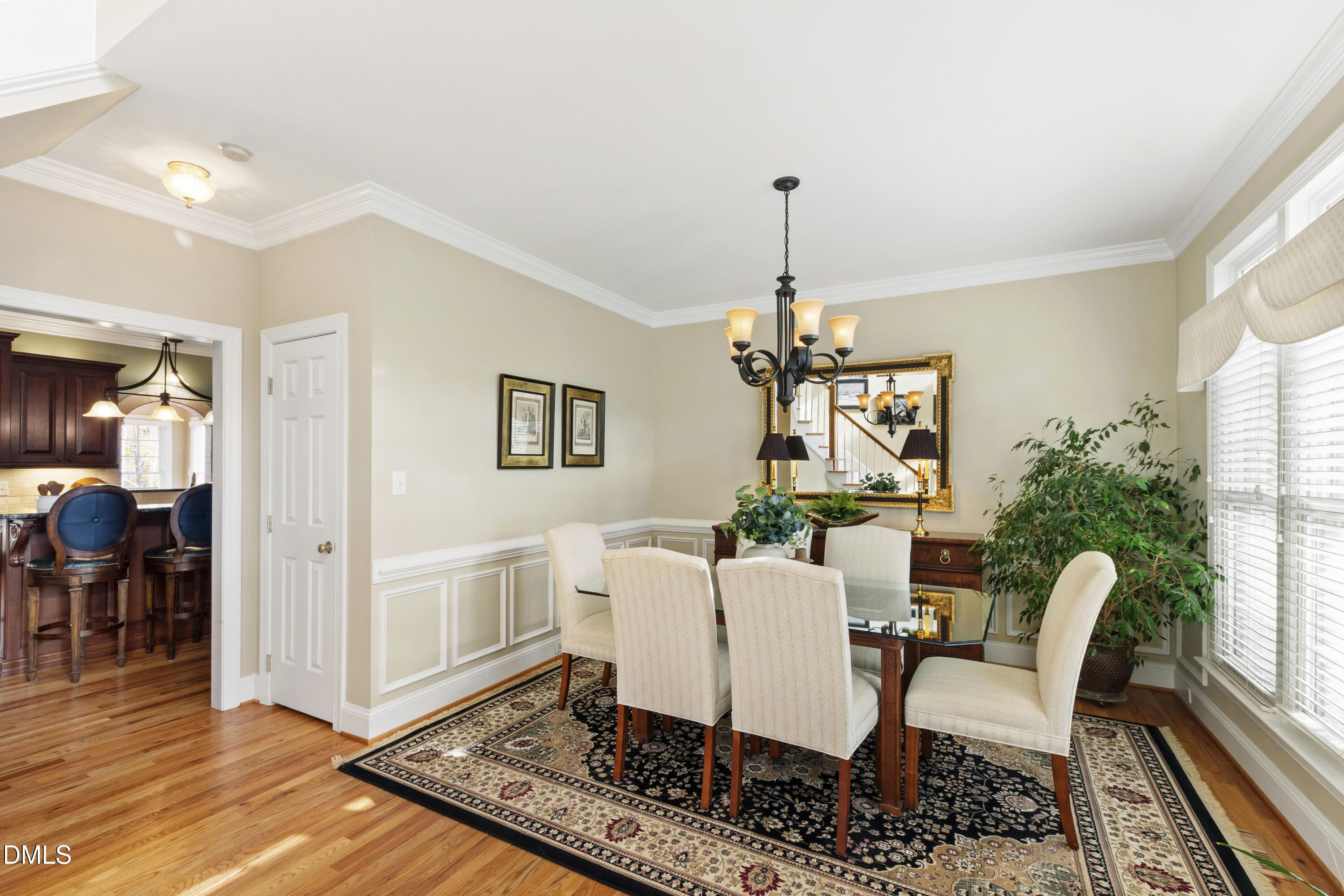 2405 Welsh Tavern Way Wake Forest, NC 27587 - Photo 26 of 58 a dining room with furniture a chandelier and wooden floor