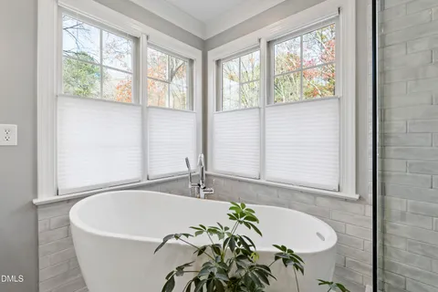 a bedroom with two beds and a chandelier