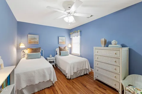 a living room with furniture a flat screen tv and a window