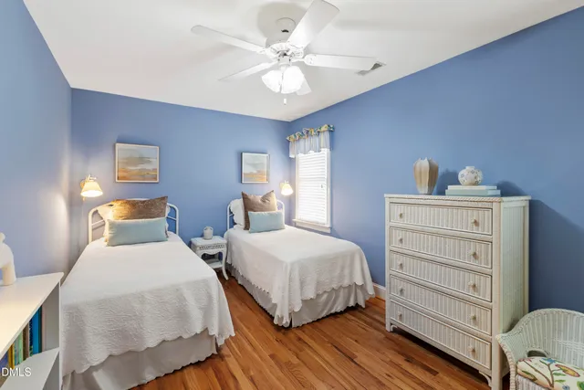 a living room with furniture a flat screen tv and a window