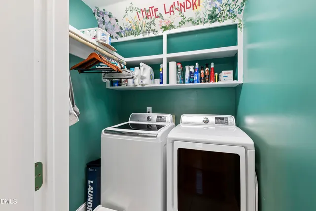 a living room with furniture a flat screen tv and a table
