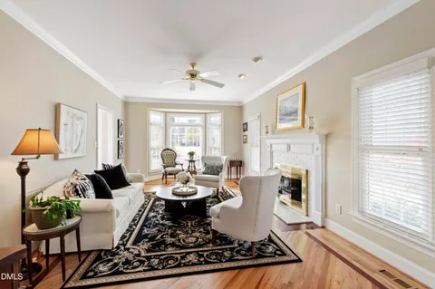 a living room with furniture fireplace and a large window