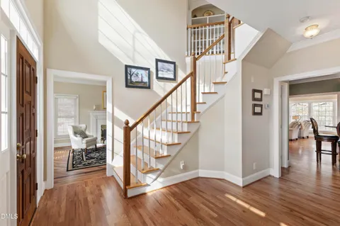 a view of entryway and hall with wooden floor