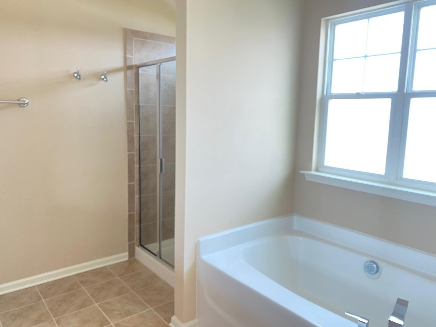 126 Zante Currant Road Durham, NC 27703 - Photo 11 of 23 a bathroom with a bathtub and a shower