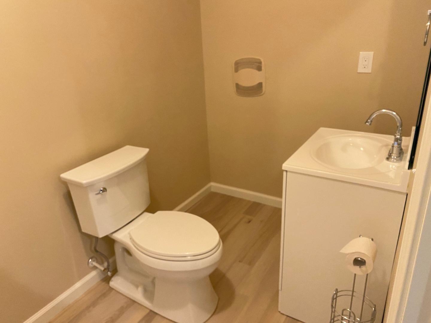 126 Zante Currant Road Durham, NC 27703 - Photo 17 of 23 a white toilet sitting next to a white sink and vanity