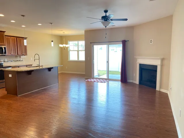 a view of a kitchen with a sink and a fireplace