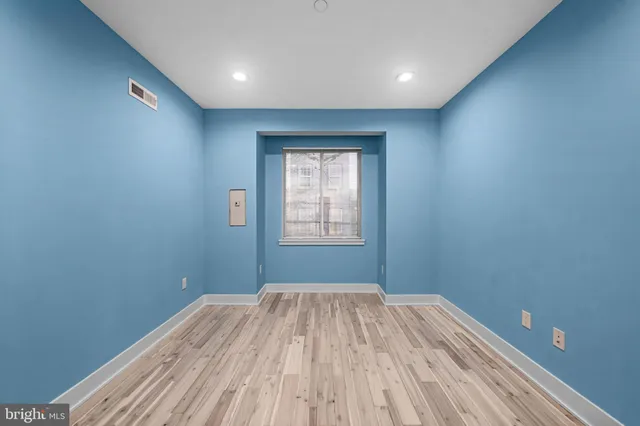 a bedroom with a bed and a potted plant