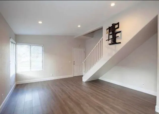 wooden floor in an empty room with a window