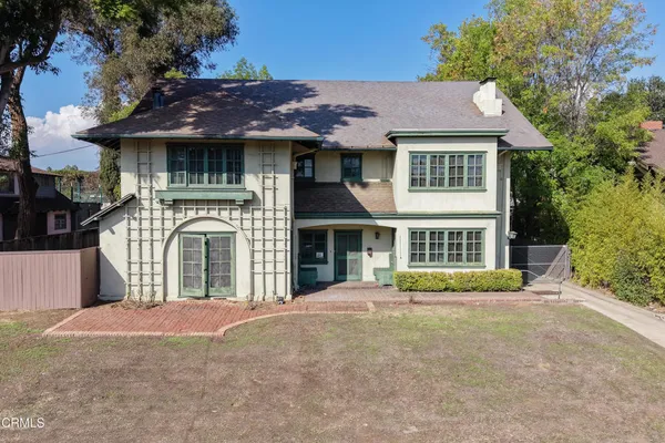 a front view of a house with a garden