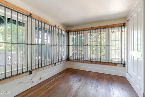 a view of a room with wooden floor