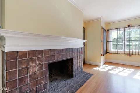 wooden floor in an empty room with a fireplace