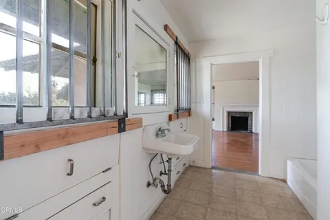 wooden floor fireplace and windows in an empty room