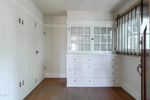 a water heater room with wooden floor
