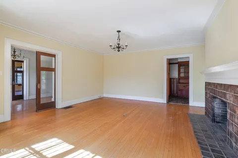 a view of a hallway with wooden floors and stairs