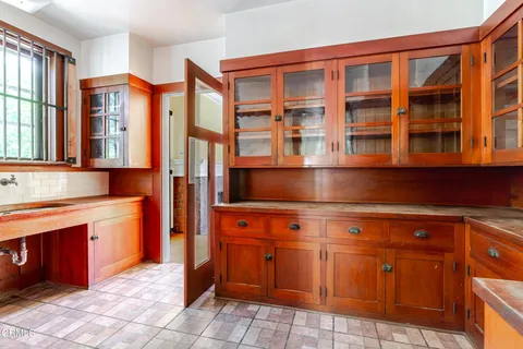 a kitchen with granite countertop a sink and cabinets