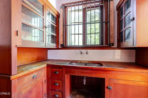 a view of a hallway view with wooden floor and windows