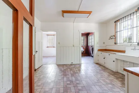 a kitchen with a stove a sink and a refrigerator