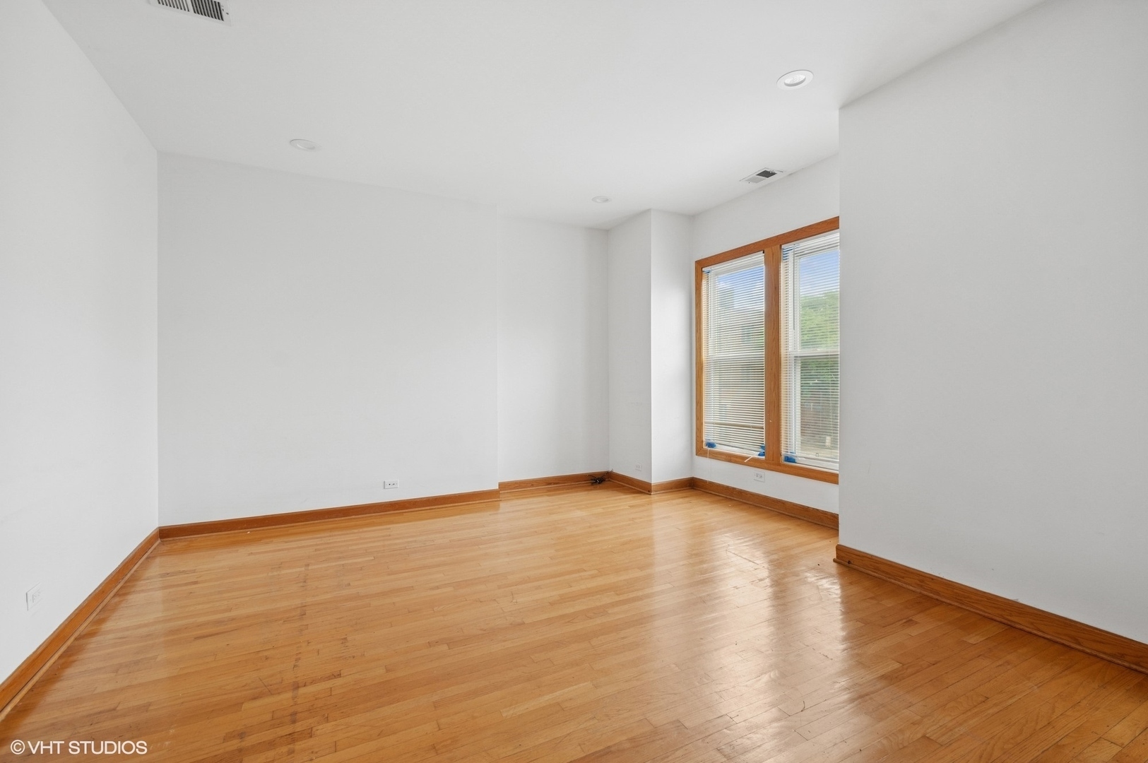 2336 West Taylor Street Chicago, IL 60612 - Photo 23 of 29 a view of an empty room with wooden floor and a window