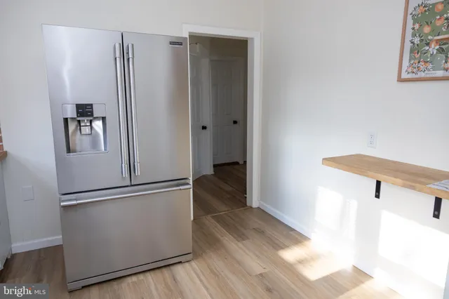 a view of a hallway with wooden floor and entryway